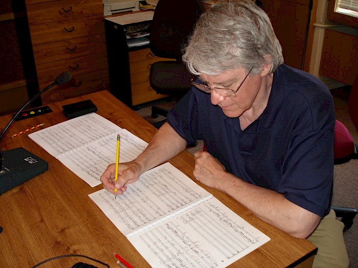 Bruce Hobson studying the recording takes in the score of Contrasts during a break.