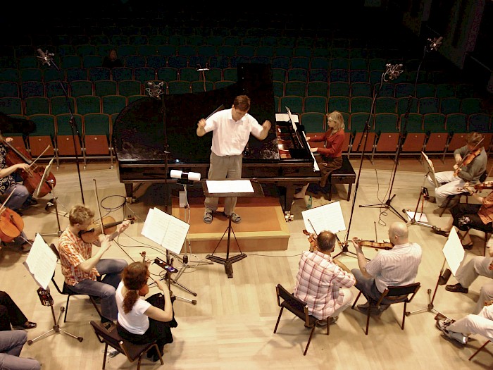 Petr Šumník conducts a rehearsal of Contrasts with The Moravian Philharmonic chamber strings and pianist Lucie Kaucká.