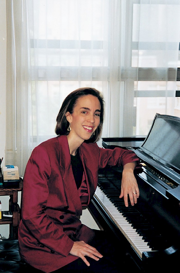 Margaret Kampmeier at the piano in her apartment